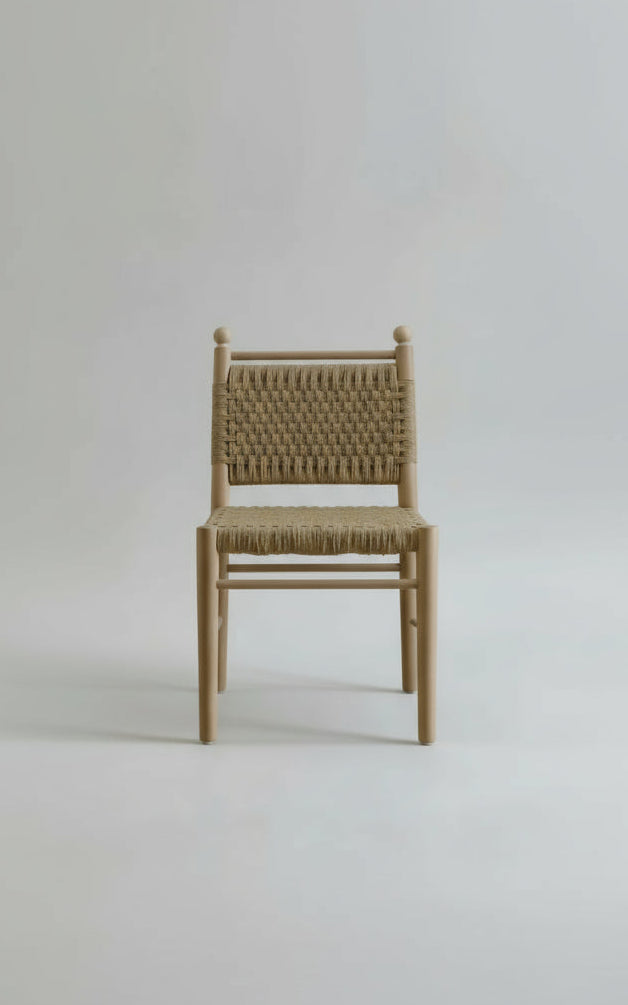 Chair with woven seat and backrest on a plain background